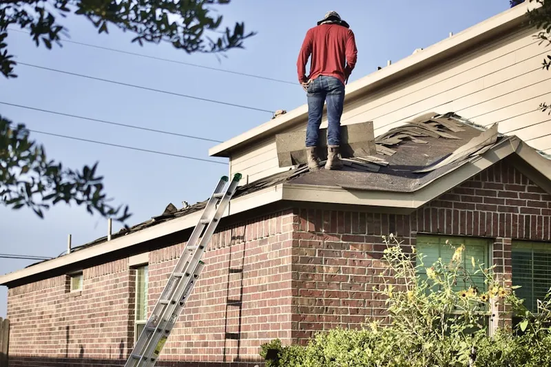 Professional roofer working on a residential roof in Flat Iron